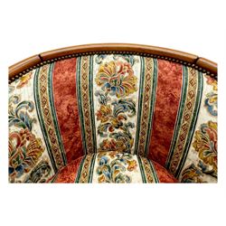 Pair of cherry wood framed tub-shaped armchairs, upholstered in striped floral fabric with brass stud trim, carved walnut frame with fluted supports capped with pinecone finials, on turned feet