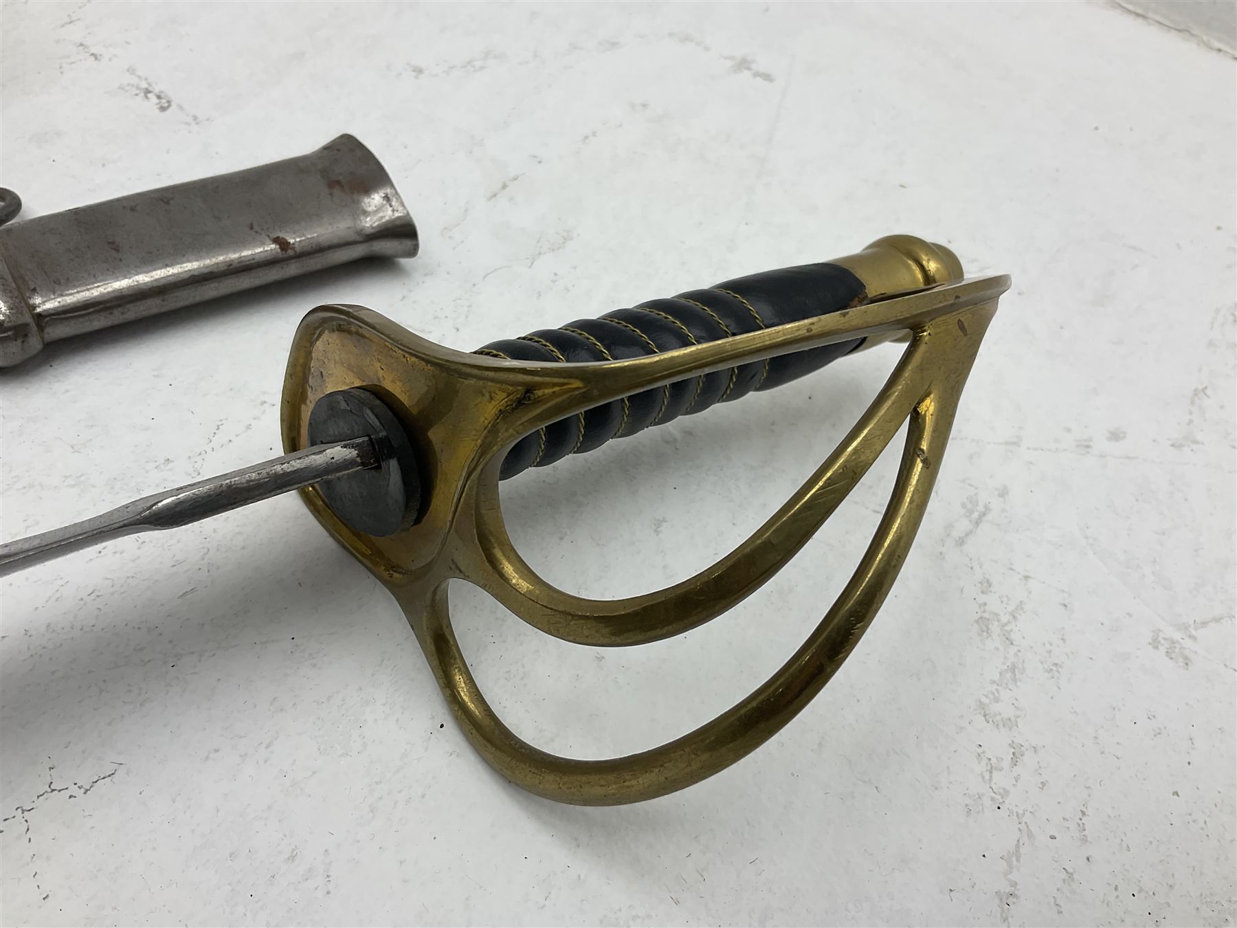 Reproduction American Civil War Cavalry trooper's sword, the 88cm slightly curving fullered steel blade marked to the ricasso 'Ames & Co Chicopee Mass.' and 'US ADK 1862'; brass hilt and leather covered grip; in steel scabbard L110cm overall;  and another reproduction sword (2)