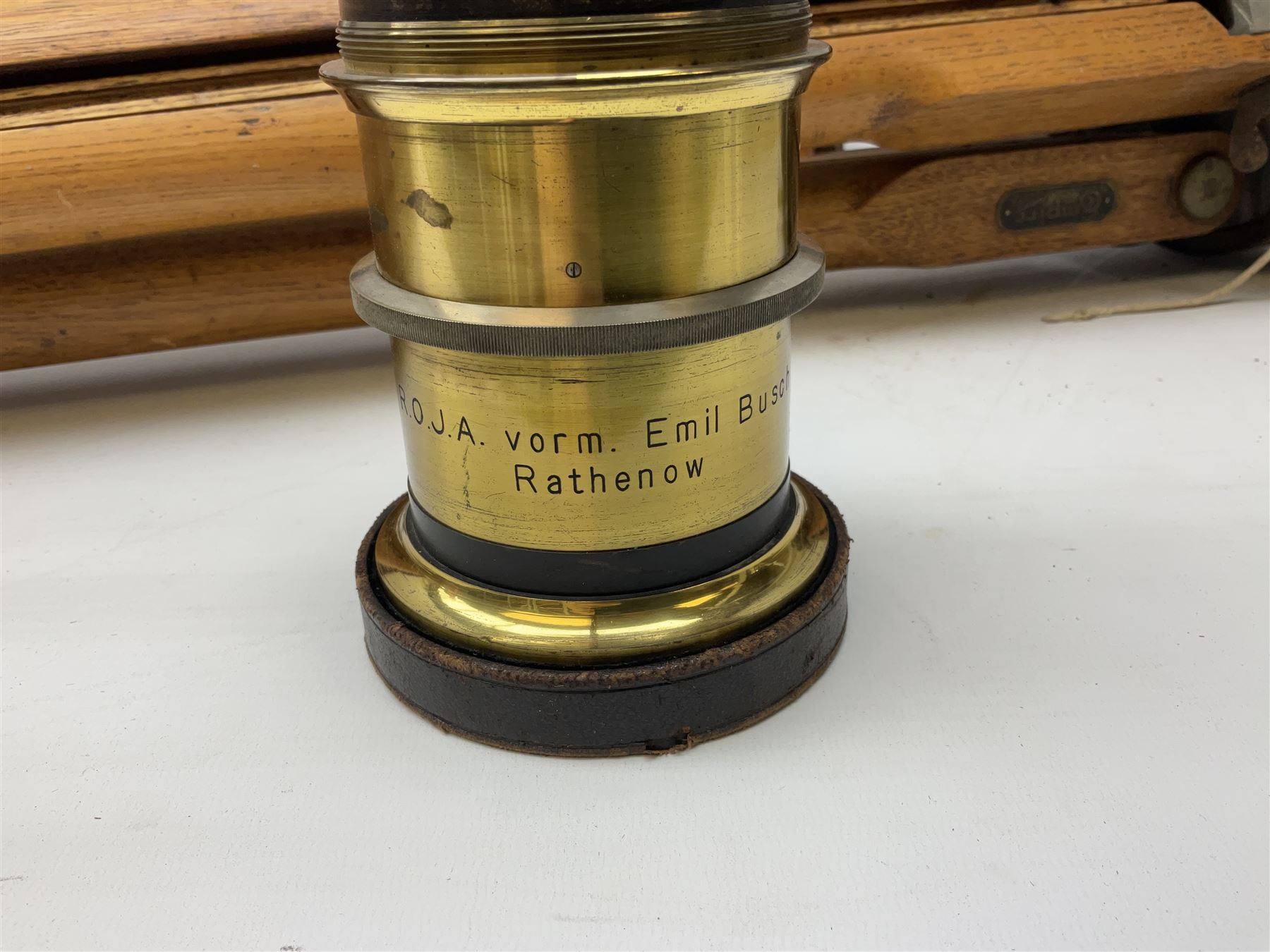 Thornton Pickard folding plate camera in mahogany and lacquered brass, no.529946 and no.529947, field model with canvas wrapped box, three mahogany photographic plates, 'Busch's Portrait Aplanat No4 Foc.14inc' lens and a wooden tripod