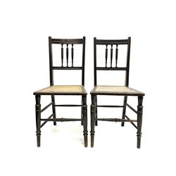 Pair of ebonised cane seat bedroom chairs, turned supports joined by stretchers
