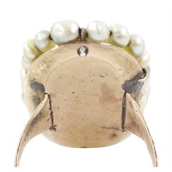 19th century portrait ring, set with an oval miniature of a woman wearing a pink dress on ivory, under a glazed panel, with threaded pearl surround and engraved shoulders. This lot has been registered for sale under Section 10 of the APHA Ivory Act