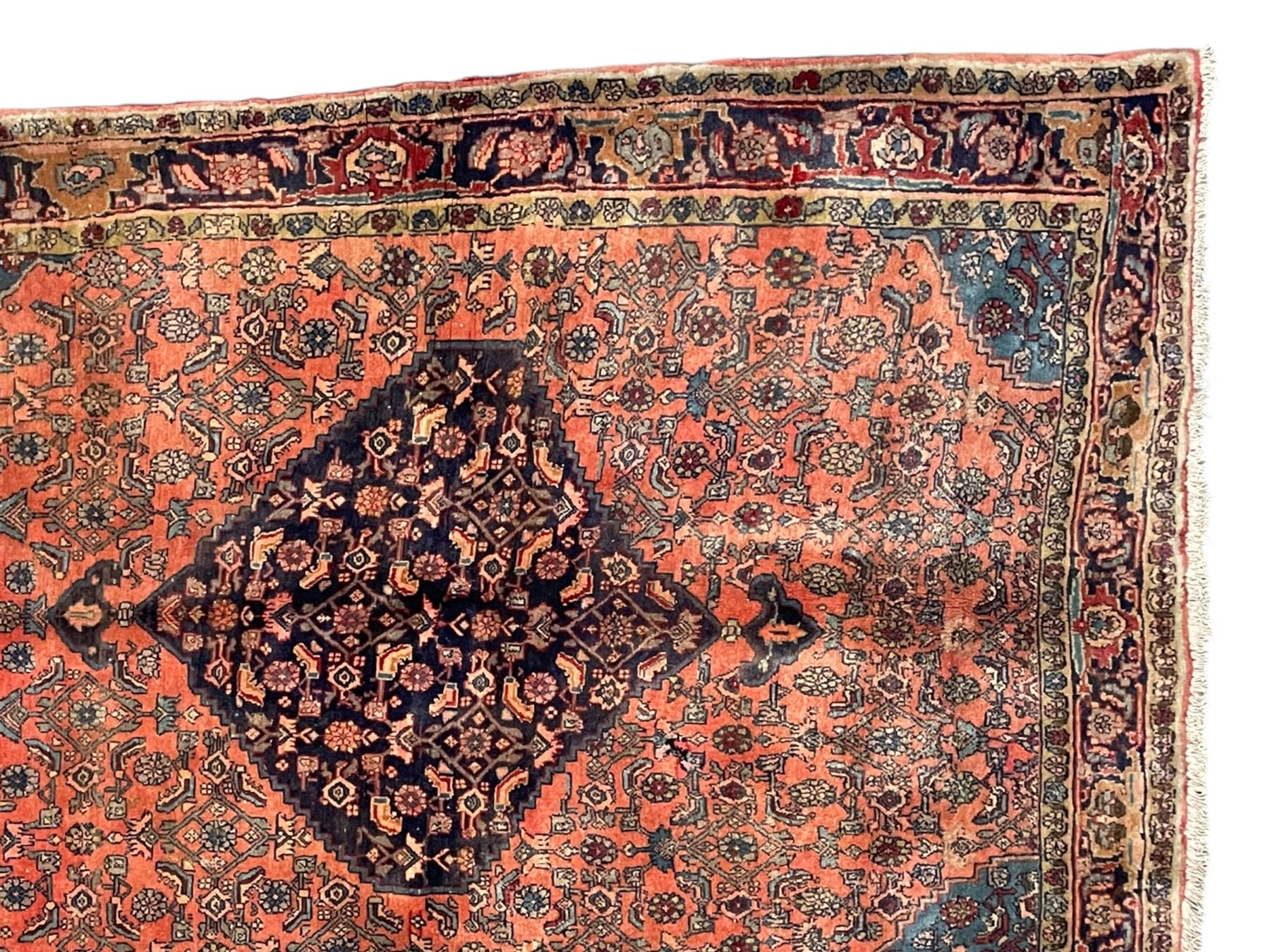 Persian Zanjan pale red ground rug, lozenge medallion and field decorated with floral Herati motifs, the border decorated with stylised plant motifs and trailing branches, floral pattern guard stripes