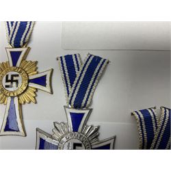 WWII set of three German Mother's Crosses, 1st Class in gilt, 2nd Class in silver and 3rd Class in bronze; all with ribbons (3)