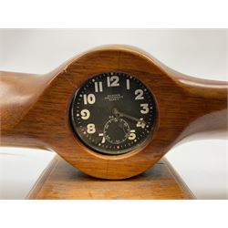 Early 20th century novelty small propeller mantle clock reputedly made by an apprentice at Blackburn Aircraft Works, Beverley & Hull in 1914, the mahogany case loosely inset with a WW1 DOXA Royal Flying Corps pocket watch, the black dial inscribed ' 30-Hour Non-Luminous Mark V.' number BE11653 with subsidiary seconds dial, the back marked with a capital 'A' above a broad arrow, mounted on a stepped square base L67cm
