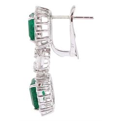 Pair of 18ct white gold emerald and diamond earrings, each stud set with two octagonal cut emeralds, with round brilliant cut diamonds, spaced by two pear cut diamonds and two further round brilliant cut diamonds, stamped, total emerald weight approx 4.85 carat, total diamond weight approx 2.85 carat