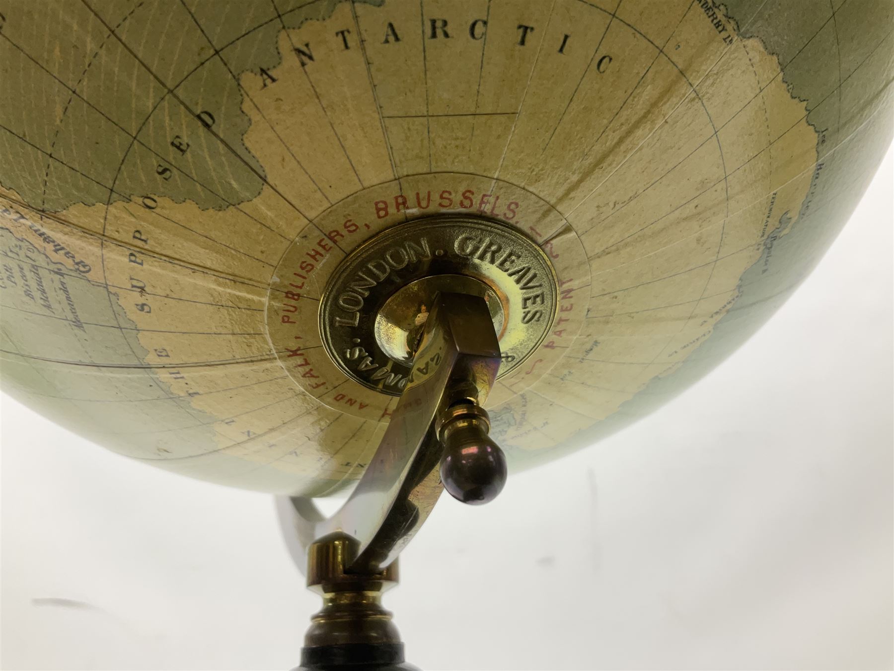 Terrestrial globe by Grinell, Washington, mounted on a brass half meridian and raised on turned wood pedestal base, H55cm