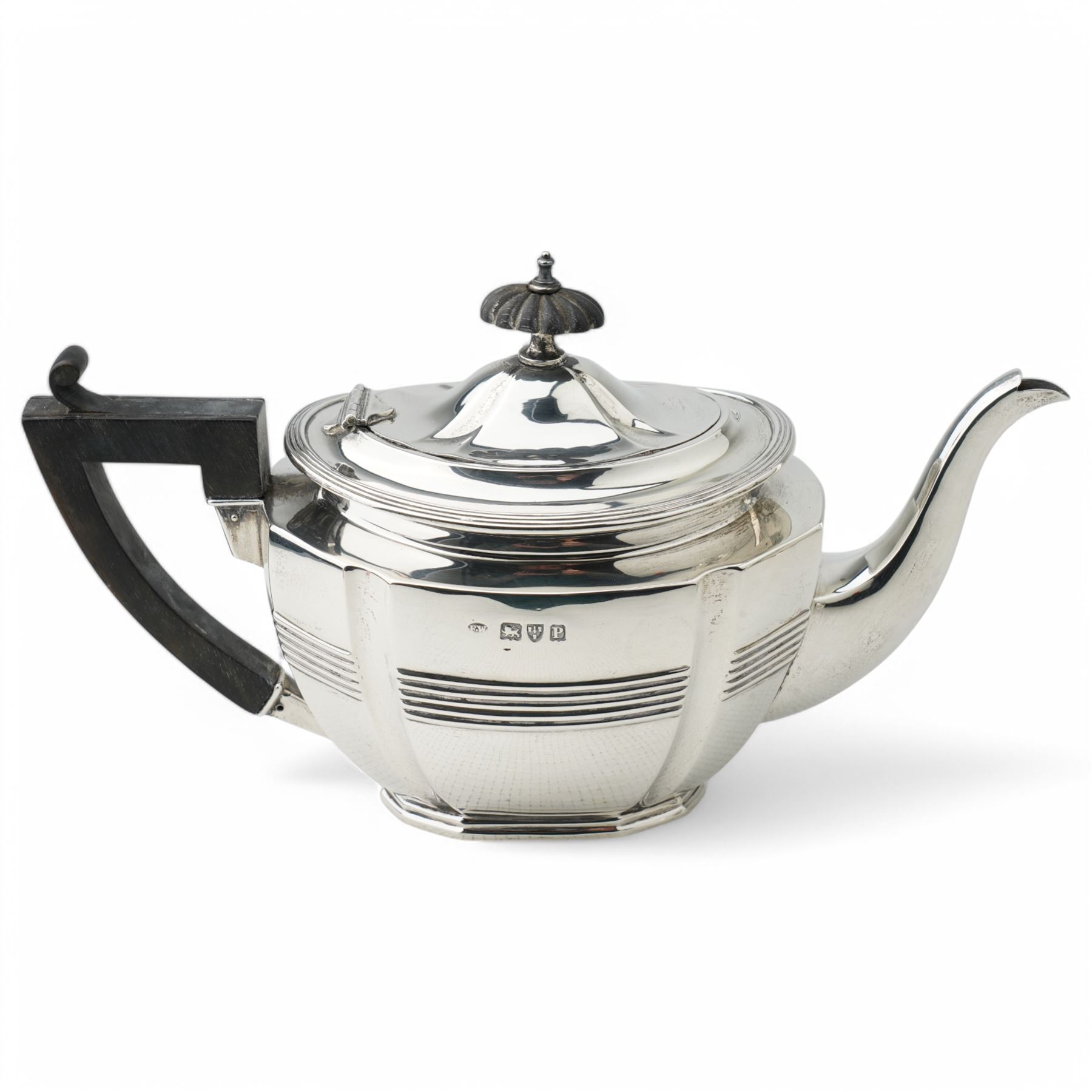 Late Victorian silver three piece tea set of panel sided oval design, the teapot with ebonised handle and lift, Chester 1898/99 Maker Florence Warden and William Aitken