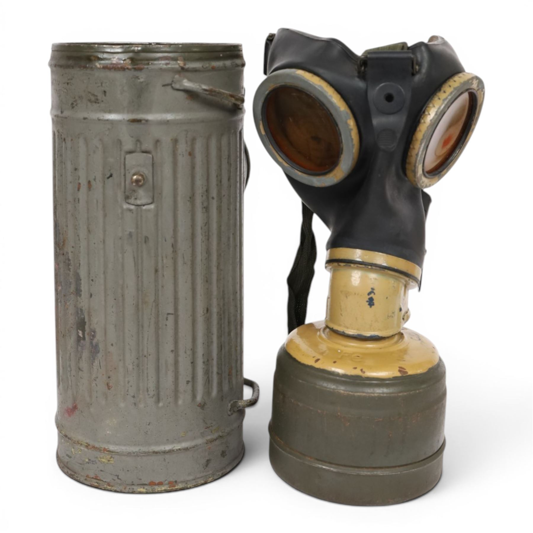 WWII German armed forces gas mask, housed in the original issue tin, tin H27cm