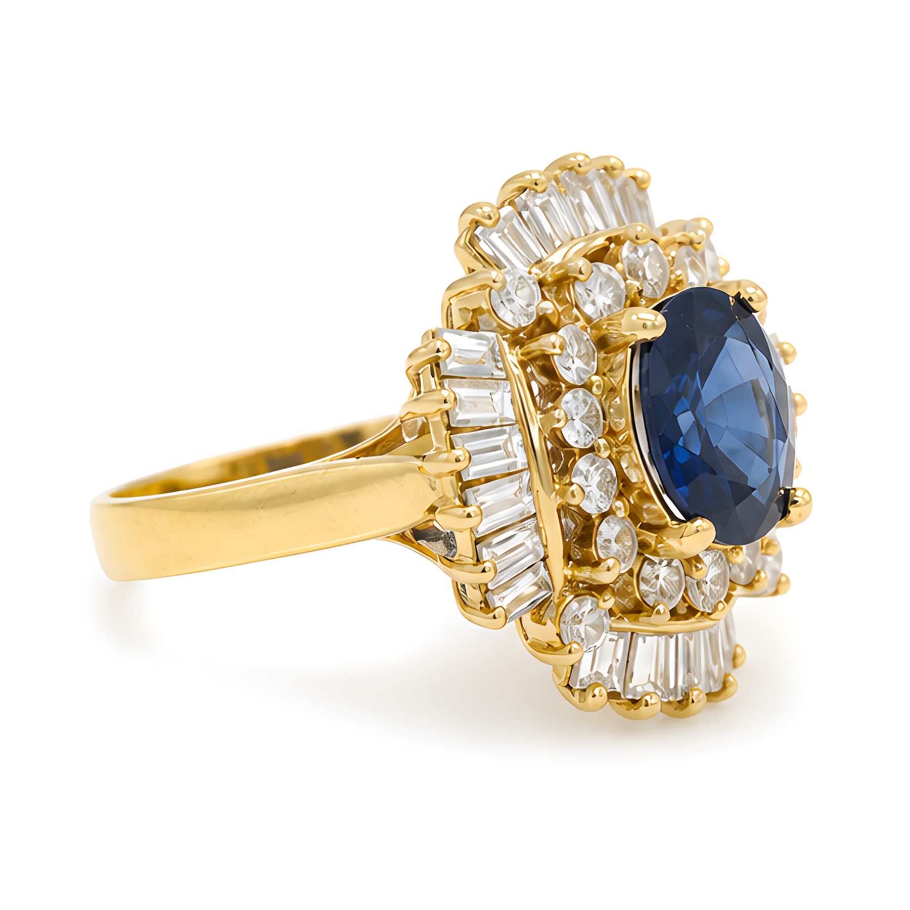 18ct gold sapphire and diamond cluster ring, single oval cut sapphire of approx 2.05 carat, surrounded by two rows of round brilliant cut and baguette cut diamonds, Sheffield import mark 1994, total round cut diamond weight approx 0.55 carat