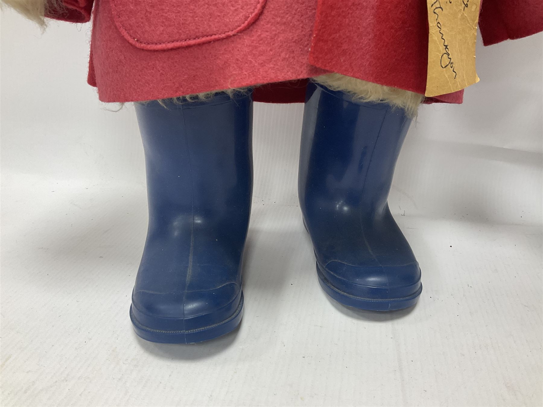 Pair of Paddington Bear teddies with amber eyes, the first example having a brown felt hat, red coat and blue PB boots with original label; the second having a grey felt hat, blue coat and blue Dunlop boots, tallest H51cm 