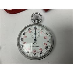 Nero Lemania - Royal Air Force type military stopwatch, outer black register for 60 seconds with 1/5th seconds divisions, inner red register to 100 with 1/10 divisions, subsidiary dial recording to 30 minutes, signed and marked with Broad Arrow, case back engraved '0552/521-3169' Broad Arrow '152/70'; together with a Balmaster Antichoc 1/10 4 Rubis stopwatch (2)
