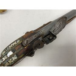 Modern non-firing reproduction Tower flintlock pistol marked with crowned GR and Tower to the lock, brass skull crusher butt and fittings L40cm overall; another Indian/Moorish reproduction flintlock pistol with mother-of-pearl inlay; and a modern die-cast replica Colt style revolver (3)