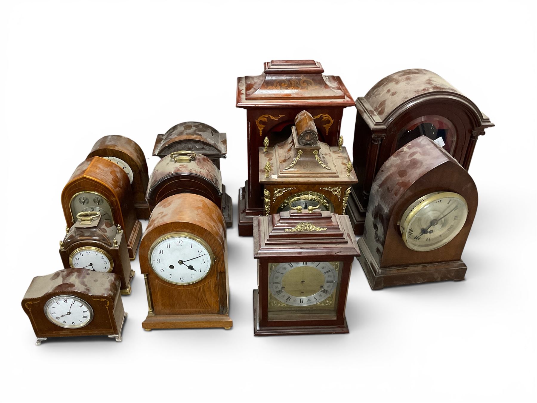 Collection of mantle clock cases, some with movements 
