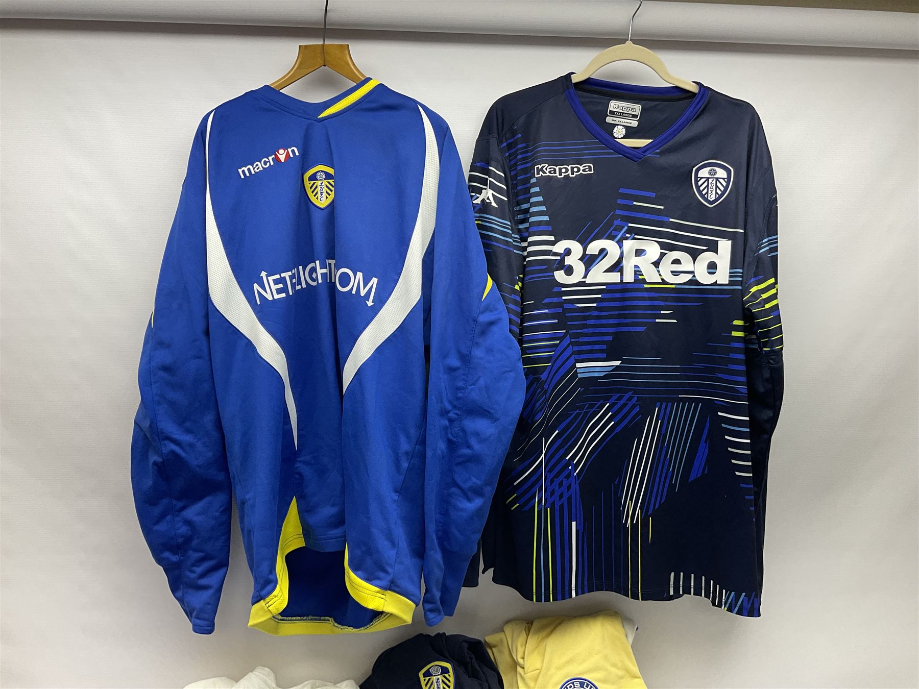 Fourteen items of replica sporting clothing including Leeds United football club shirts, England jerseys etc