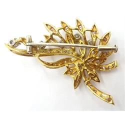  18ct gold diamond floral brooch, six principle diamonds and diamond set leaves stamped 750, 4.4cm approx 10.3gm  