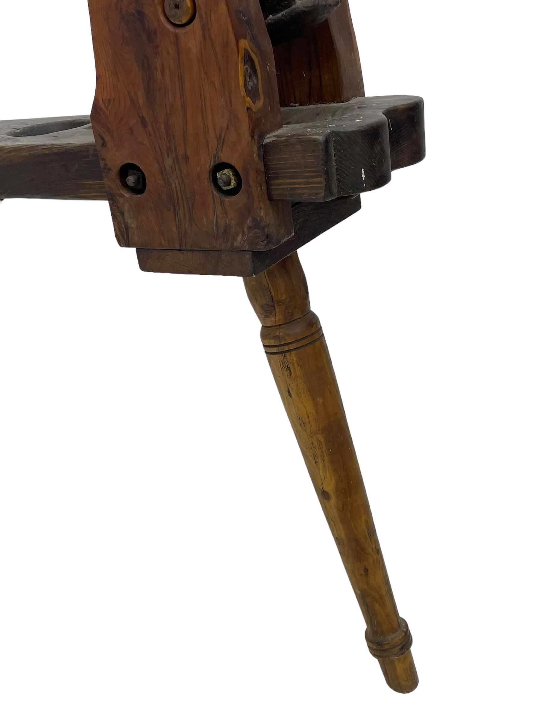 Early 19th century cobbler's work bench, in various woods, revolving cast iron last on yew wood supports, pine seat with inset maker's plaque inscribed 'No 7 Josh Blacker Harehills Leeds', on turned elm front supports and turned beech rear supports 