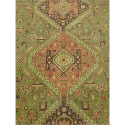  Large Persian style green ground rug, three central medallions, repeating border (353cm x 260cm) and a beige ground rug, patterned field (240cm x 174cm) (2)  