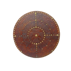  Replica Scottish Highlander's Targe by Joe Lindsay, based on a 17th century original which came from Skye, the wooden shield covered in tooled leather with traditional Celtic designs, brass studs and mounts with deer skin hide verso, D49cm   