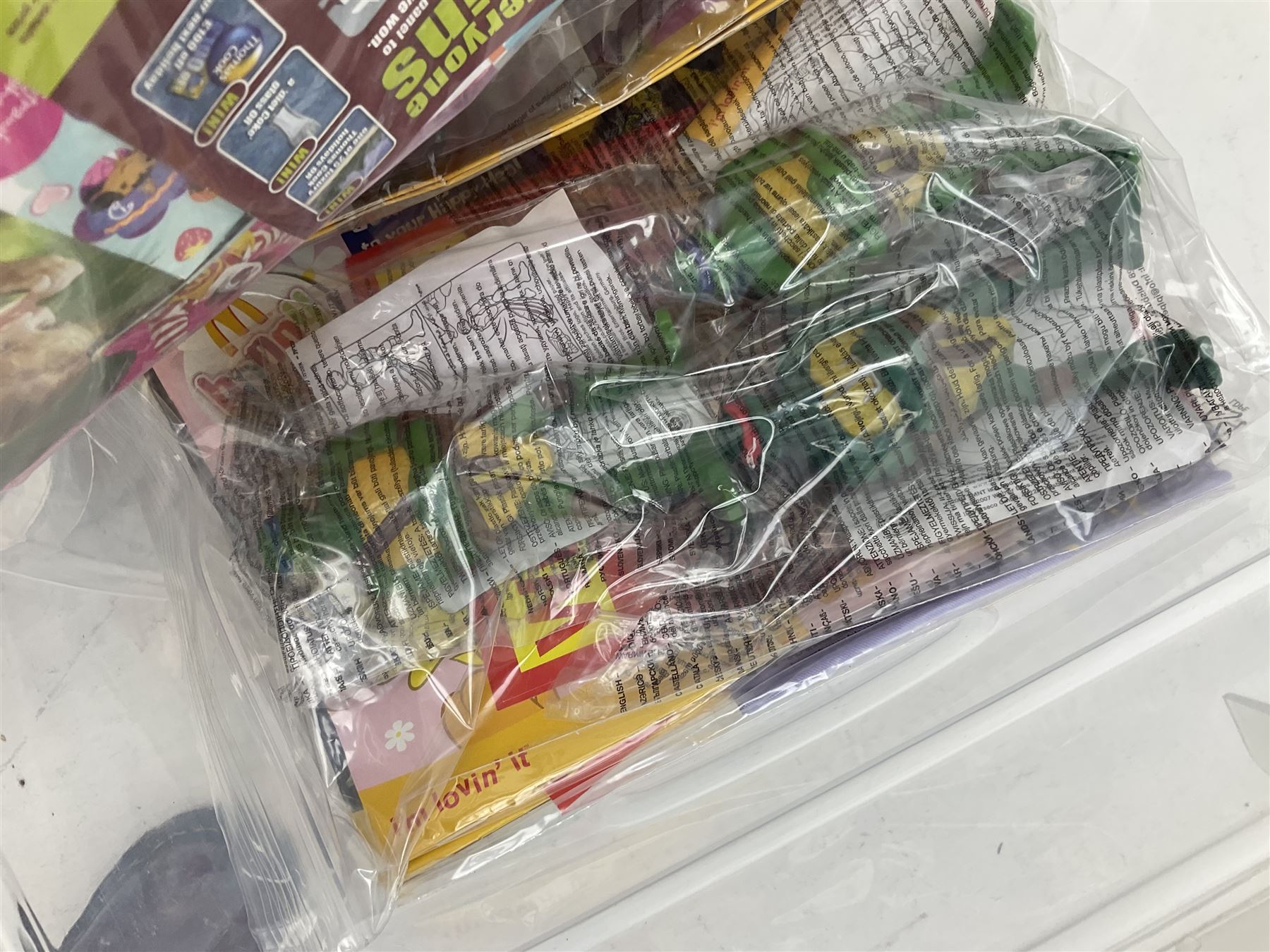 Large quantity of Mcdonalds toys to include Herbie and Polly Pocket in three boxes
