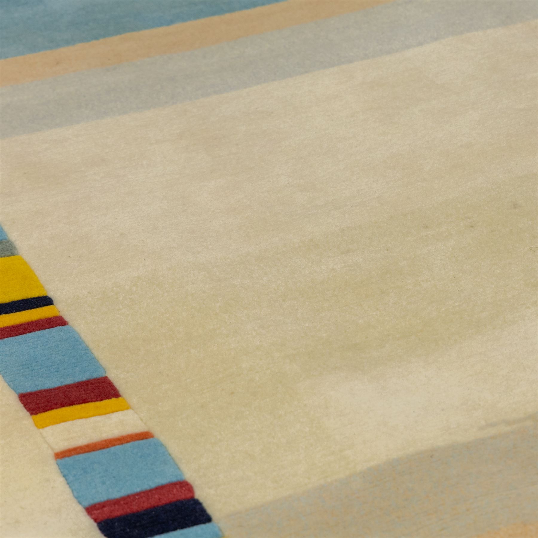 Rugs by Design - ‘Sand Bar’ Nepalese thick pile wool rug, with abstract horizontal bands in cream, blue, camel and dark brown tones, centred by a narrow multicoloured vertical stripe