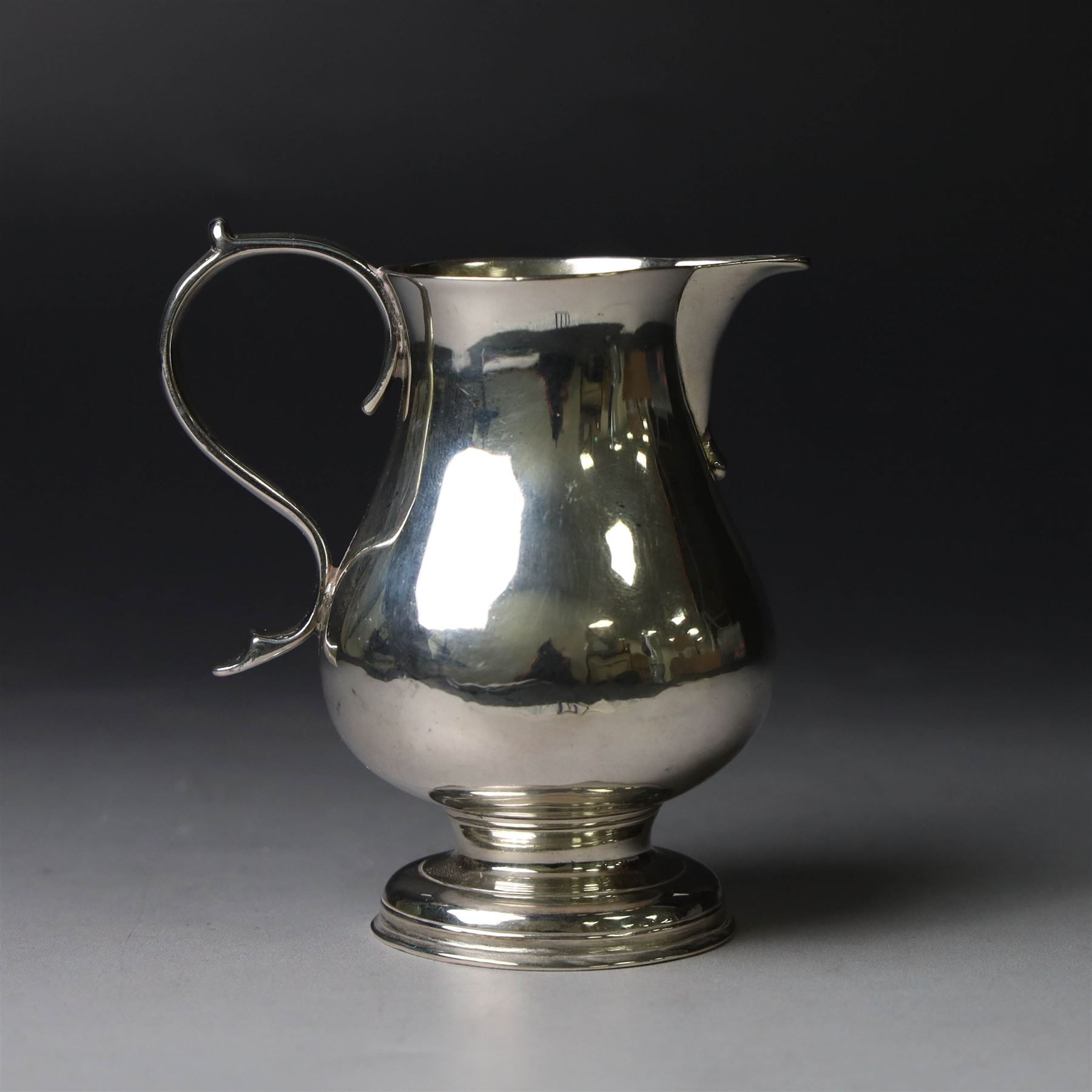 George II silver cream jug, of plain bellied form with capped scroll handle and sparrow beak, upon stepped circular foot, hallmarked London 1737, makers mark indistinct, H8.5cm
