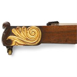 Regency rosewood sofa table, rectangular top with variegated rosewood veneers, hinged D-shaped leaves, over a set of dummy drawers to the back and full-size drawers to the front, with turned knob handles and gilt beaded moulding on frieze above elegant turned, tapering, and fluted, pedestal with a well-carved collar, supported on a large, tripartite concave platform base terminating in richly carved lion paw feet with gilded acanthus leaf carving, on concealed brass castors, circa 1815, length extended 161cm 
