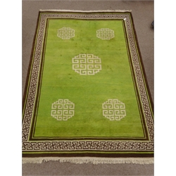  Large oriental brown and green ground rug, geometric pattern field, repeating border, made to order in the Tibetan Refugee Centre, Darjeeling in 1976, 254cm x 370cm  
