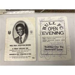 Hull F.C. memorabilia; Clive Sullivan 1986 memorial game programme, Open Evening 1994 programme with multiple player signatures, 'Old Faithful' 45rpm record, Wembley rosettes, 2000 team poster with facsimile signatures, framed print 'Farewell to the Boulevard 1895-2002', fully signed team photograph, various booklets, CD, DVD etc; and a folder containing the Merlin Rugby League card collection