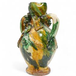 Two early 20th century Italian glazed terracotta wine flasks, one of twin handled form, applied with shells and insects, the other formed as a male figure, H24cm (2)