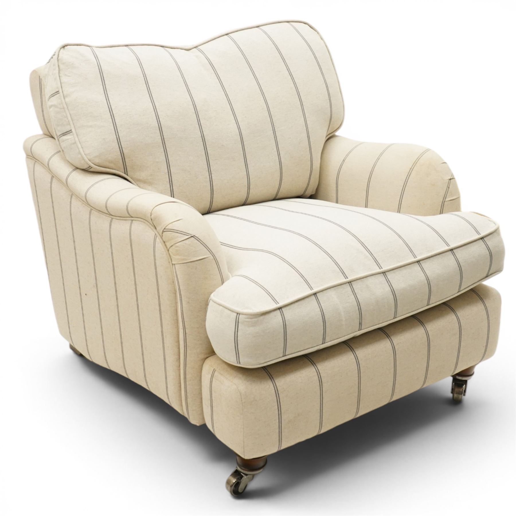 Pair of 20th century Howard shape armchairs, deep seat armchairs in cream and grep striped upholstery, raised on dark supports terminating in front castors