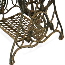 Early 20th century Singer treadle sewing machine, the black enamel machine with gilt floral and scroll transferwork set within a timber cabinet top with folding leaf, raised on cast-iron base with pierced geometric treadle and 'Singer' name stretcher, flanked by two small drawers