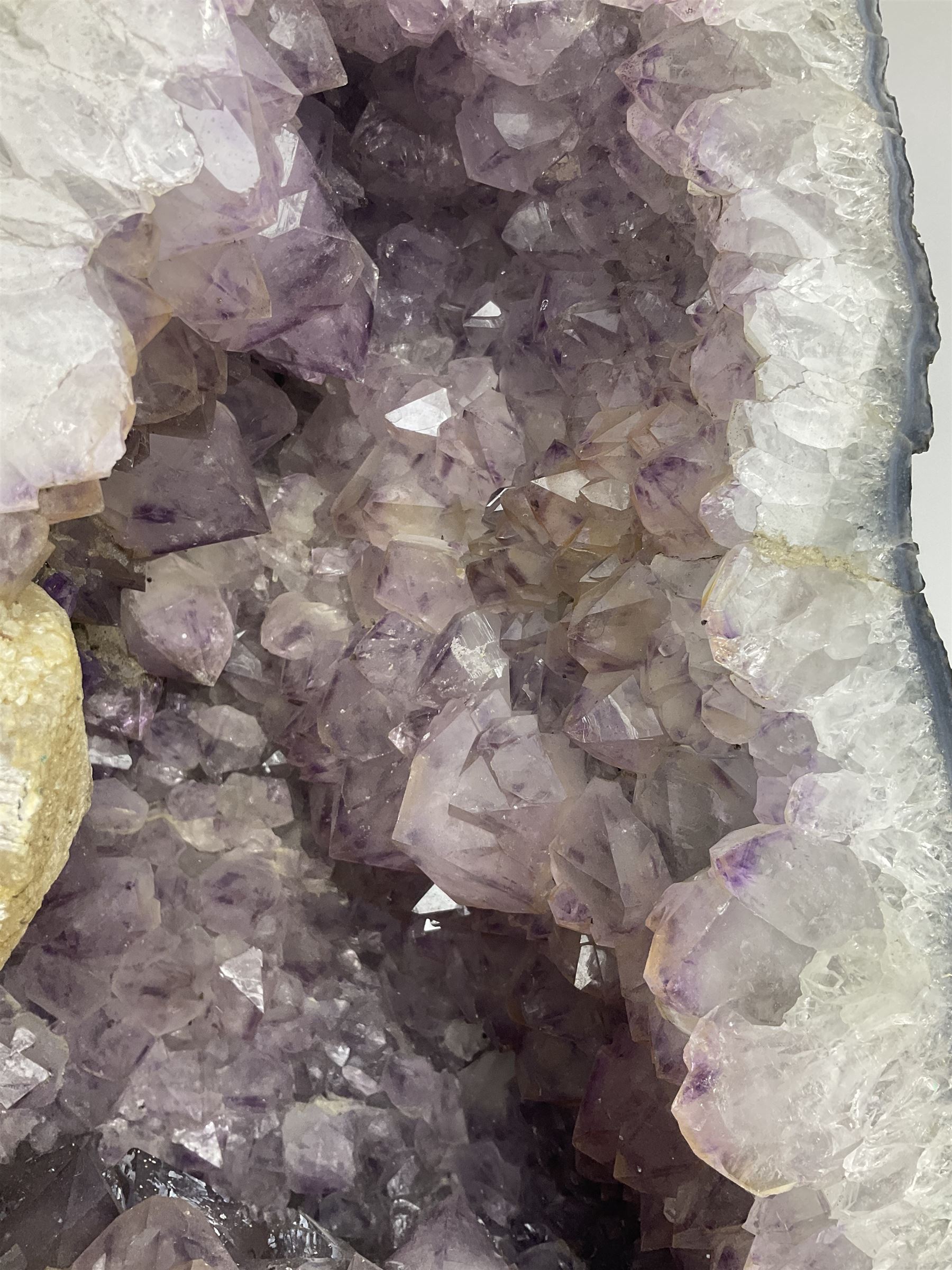 Amethyst crystal ‘cathedral’ geode, free standing with flat base and prepared outer surface, with well-defined crystals of various sizes within the cavern, H39, L32cm