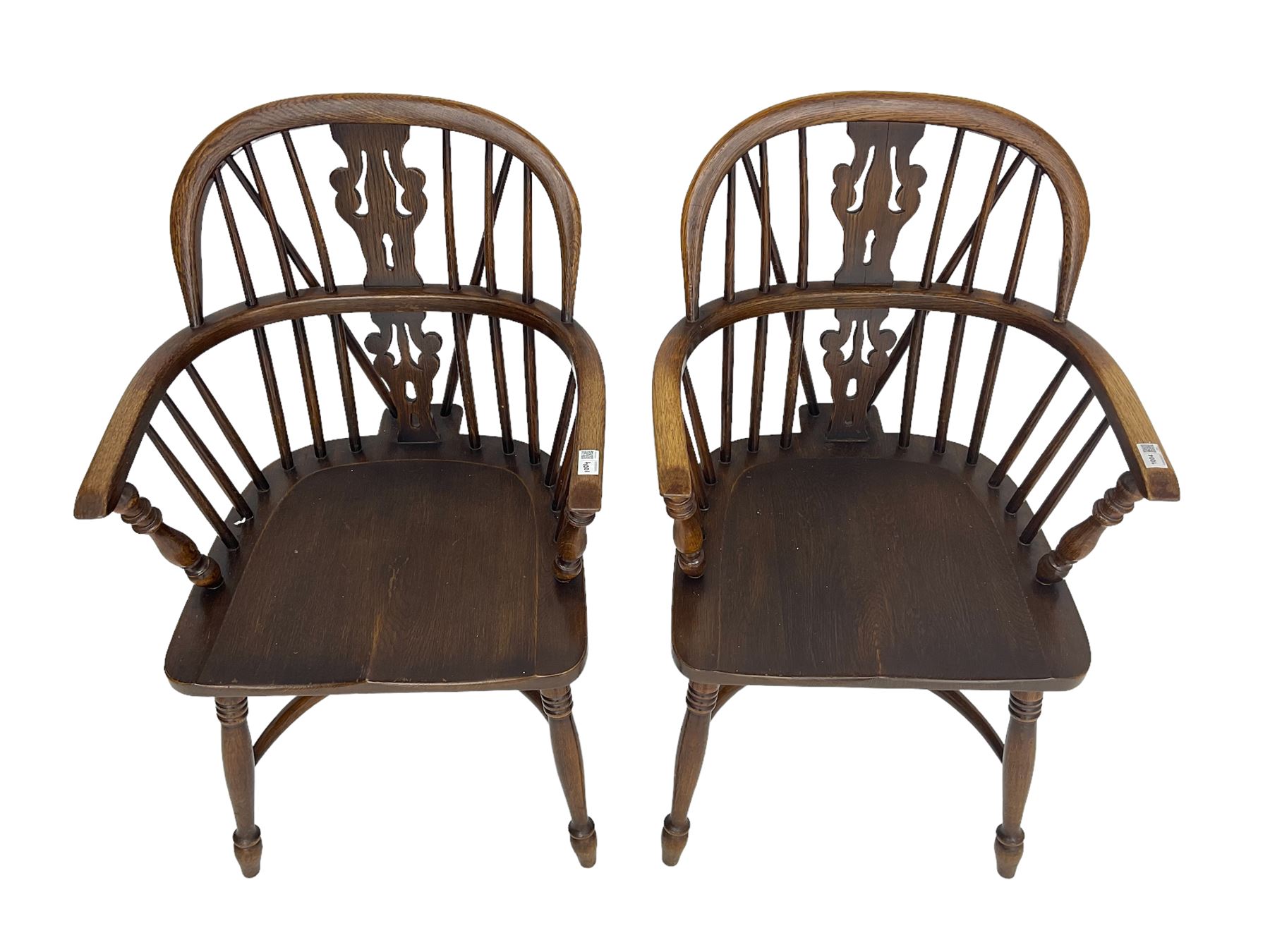 Pair late 20th century oak Windsor elbow chairs, double hoop and stick back with pierced and fretwork work splat, dished seat on turned supports joined by crinoline stretcher