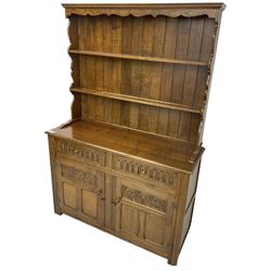 Mid-20th century oak dresser, raised two heights plate rack over two drawers and two cupboards