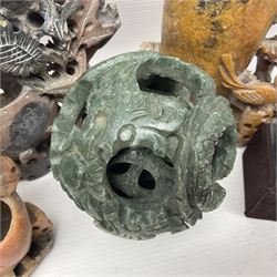 Carved soapstone puzzle ball, together with carved walnut shell and three soapstone brush pots, ball D12cm