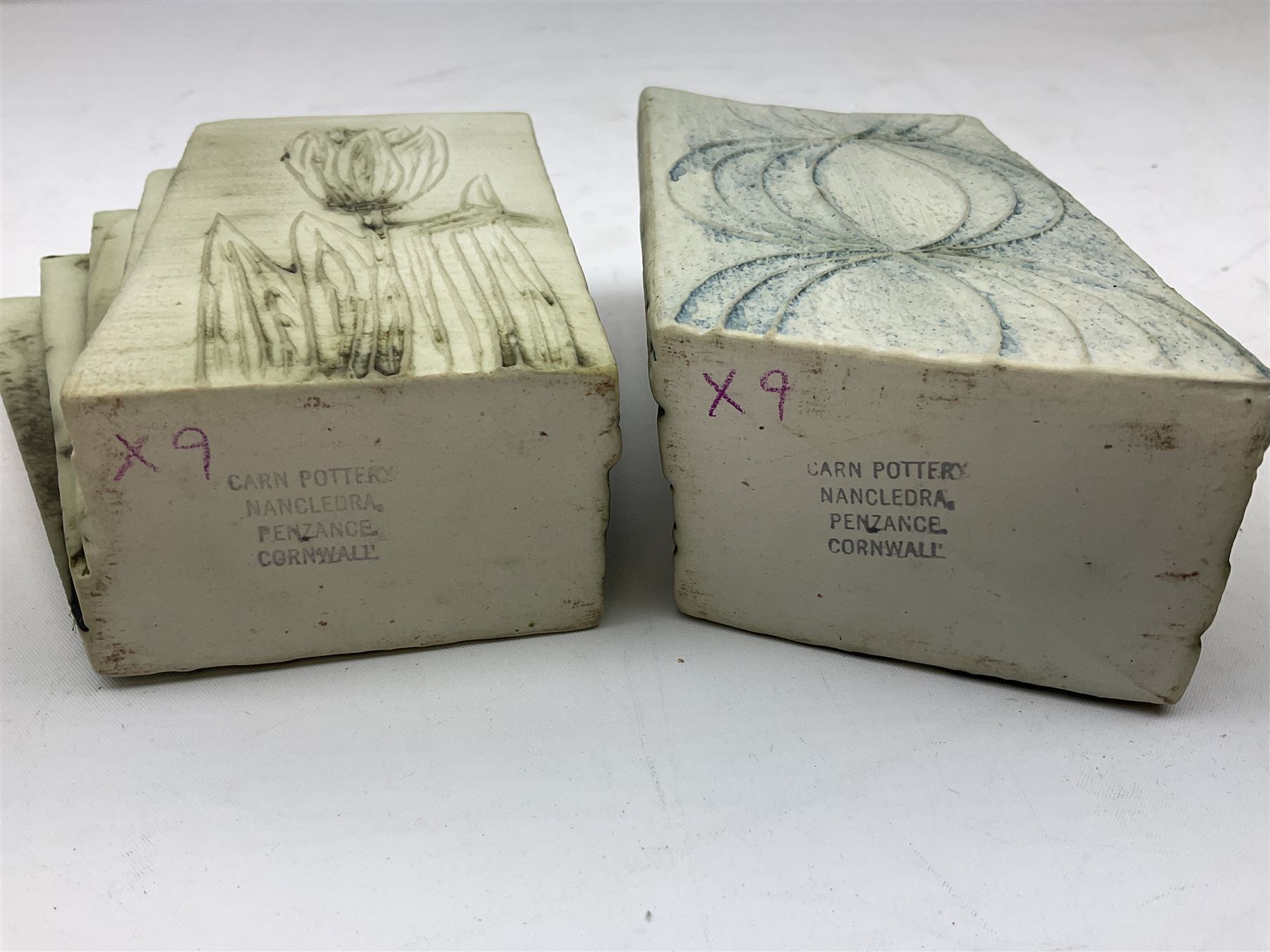 Pair of Carn Pottery Penzance vases of fan form, with tube lined floral and stylised decoration, stamped and marked X9 to base, H11.5cm