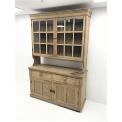 Early 20th century pine dresser, raised display cabinet, two glazed doors enclosing two shelves above two drawers and two cupboard doors 