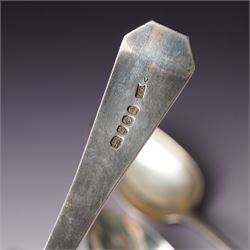 George III silver basting spoon London 1772, another engraved with initials London 1802 Thomas Wallis II, pair of table spoons London 1791 Maker Peter and Ann Bateman and two dessert spoons