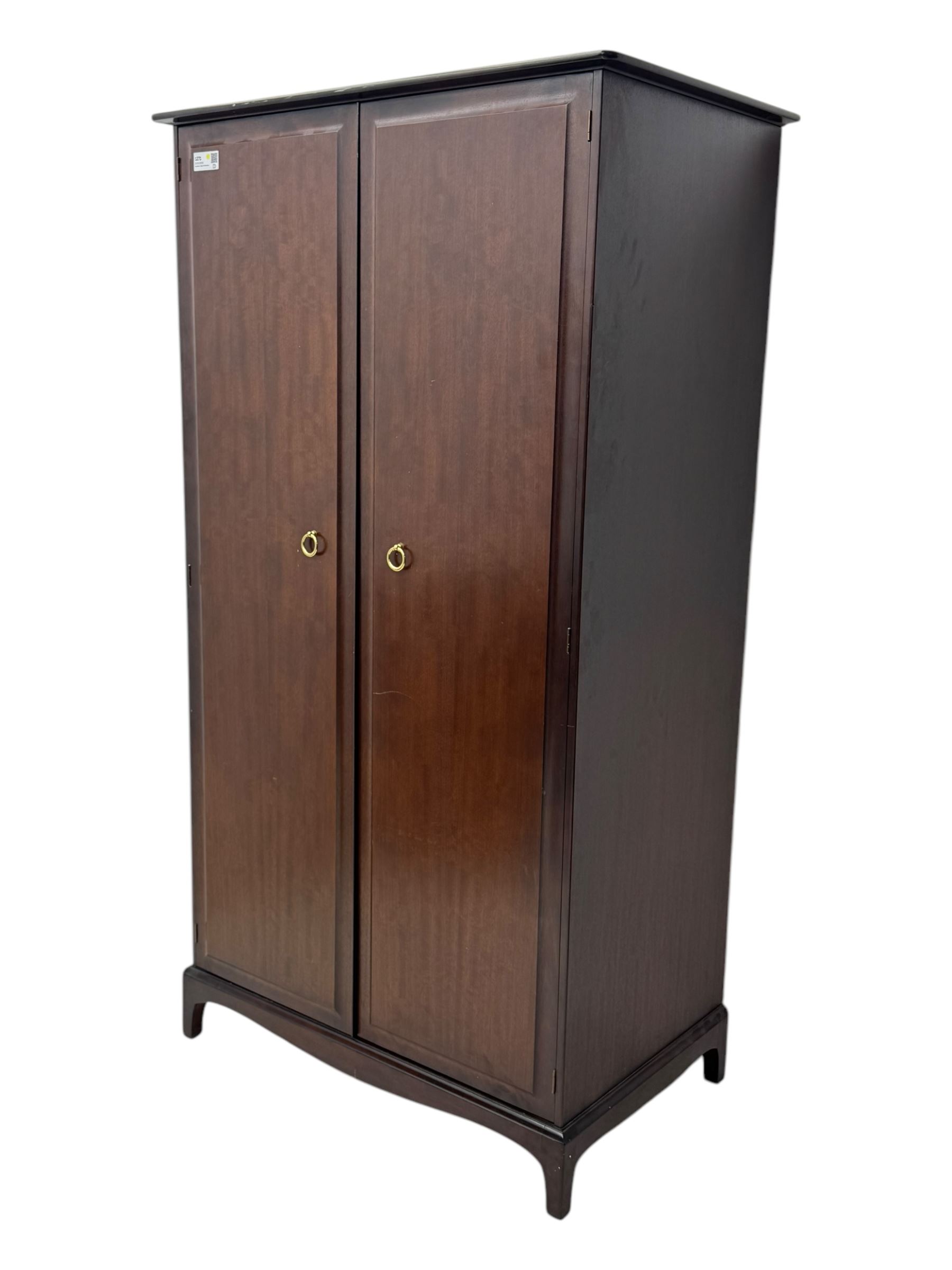 Stag Minstrel - pair of mahogany double wardrobes, comprising a larger wardrobe with a shelf and hanging rail behind two panelled doors (W127cm, D59cm, H177cm); and a smaller wardrobe enclosing a single hanging rail (W96cm, D59cm, H177cm), both finished with projecting cornices and raised on bracket feet



