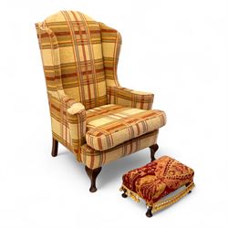 20th century Georgian style upholstered wingback armchair with footstool, the chair in yel...