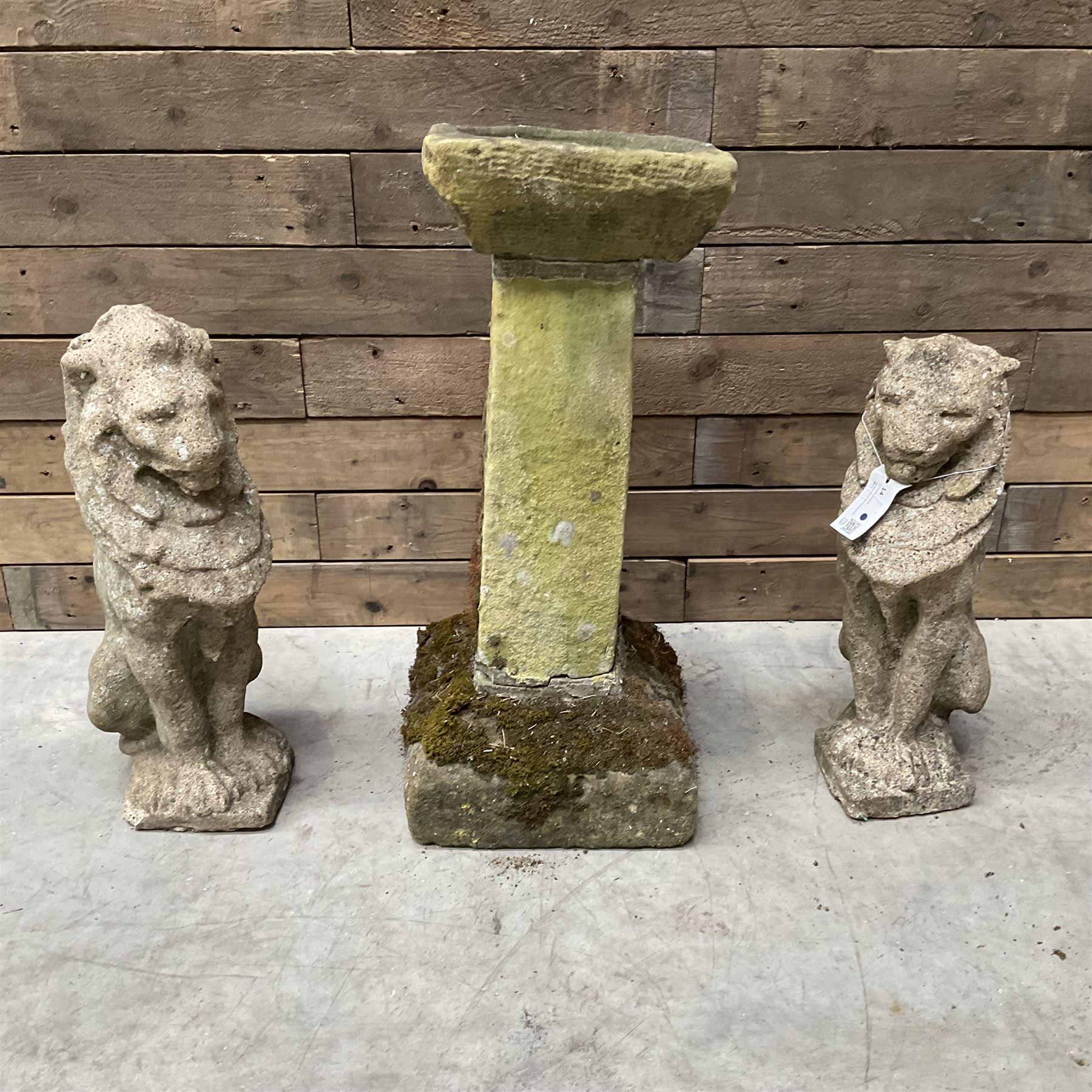 Pair of cast stone seated garden lions, a stone bird bath and various pots and planters