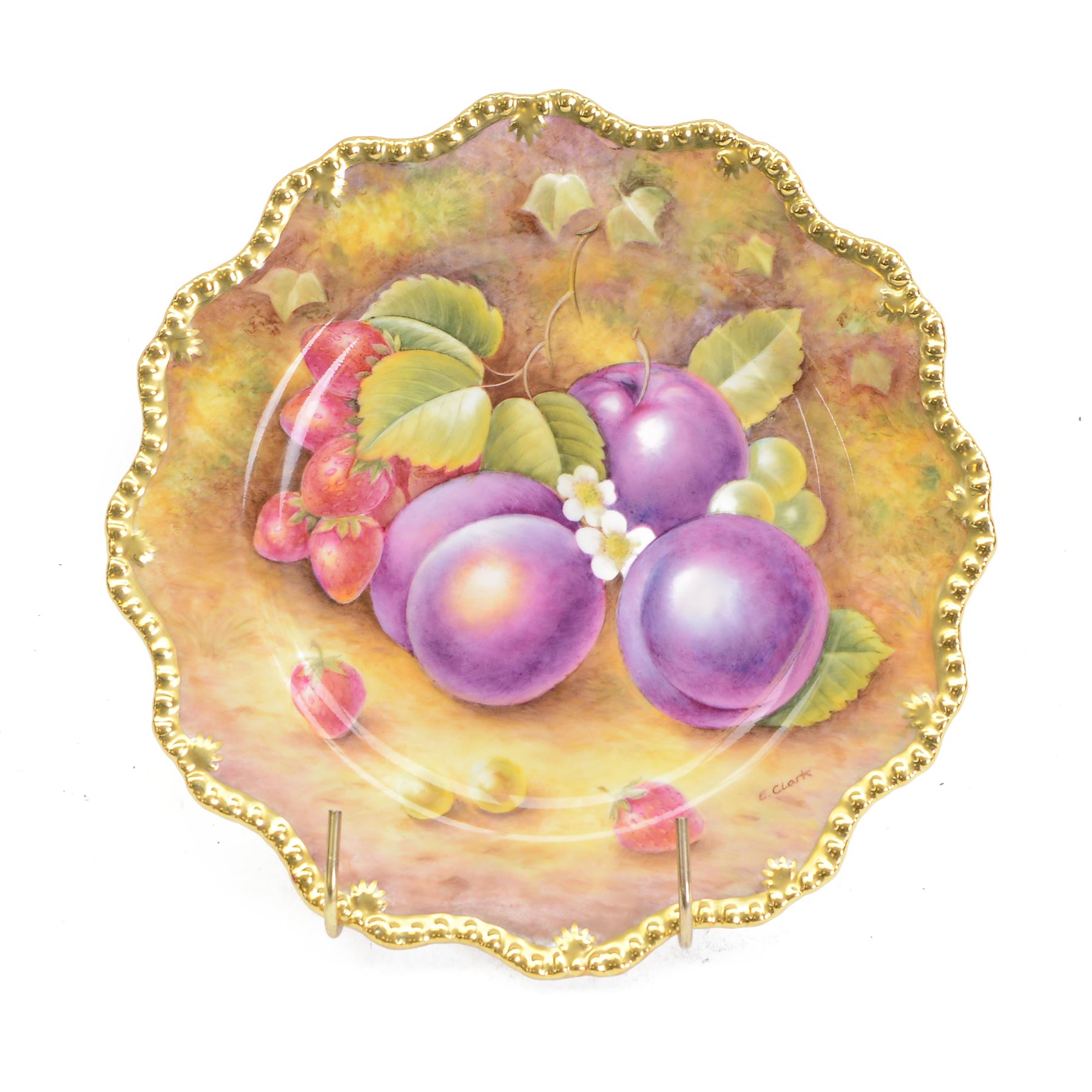 Late 20th century Royal Worcester star plate, of circular form with shaped with gilt shaped rim, hand painted by E Clark with still life of fruit upon mossy ground, signed E Clarke, with marks beneath including limited edition no 28/100, with makers fitted card box, D23cm
