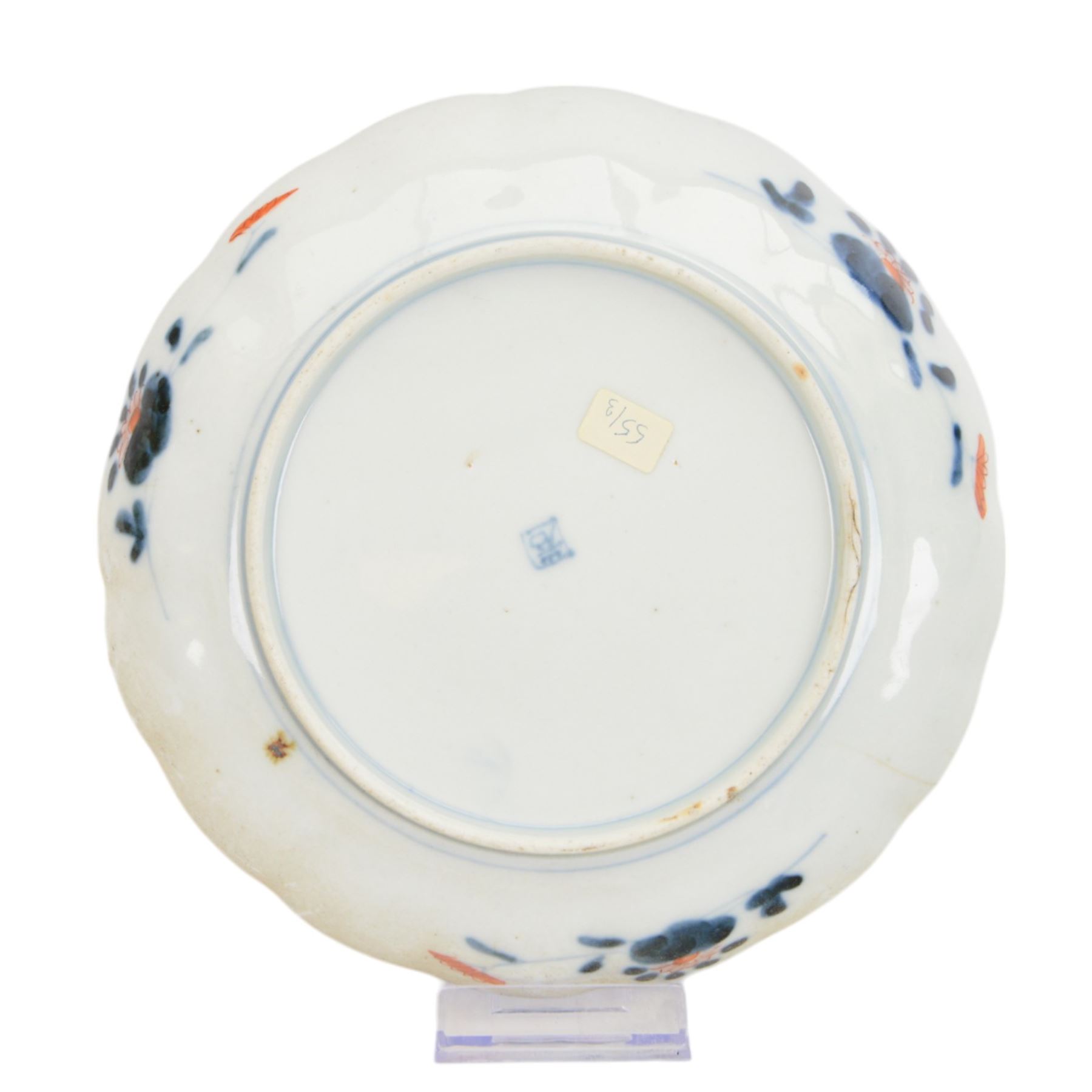 Group of 19th century Japanese Imari porcelain, Meiji period, comprising pair of lobed dishes, decorated stylised reserves and painels in blue and gilt upon a red ground, H6.5cm D21.5cm, a pair of plates of circular lobed form, decorated with a central panel depicting a vase beneath pine branches, and surrounded by panels of flowers and stylised quatrefoil shapes, D21cm, and another similar example painted with a character in underglaze blue to the centre, with character mark beneath, D22cm, each with character marks beneath               