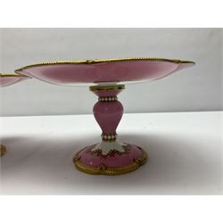 Victorian dessert service, comprising four comports and nine plates, each decorated with floral sprigs to the centre with a pink and gilt border, largest comport H13cm, plate D22.5cm