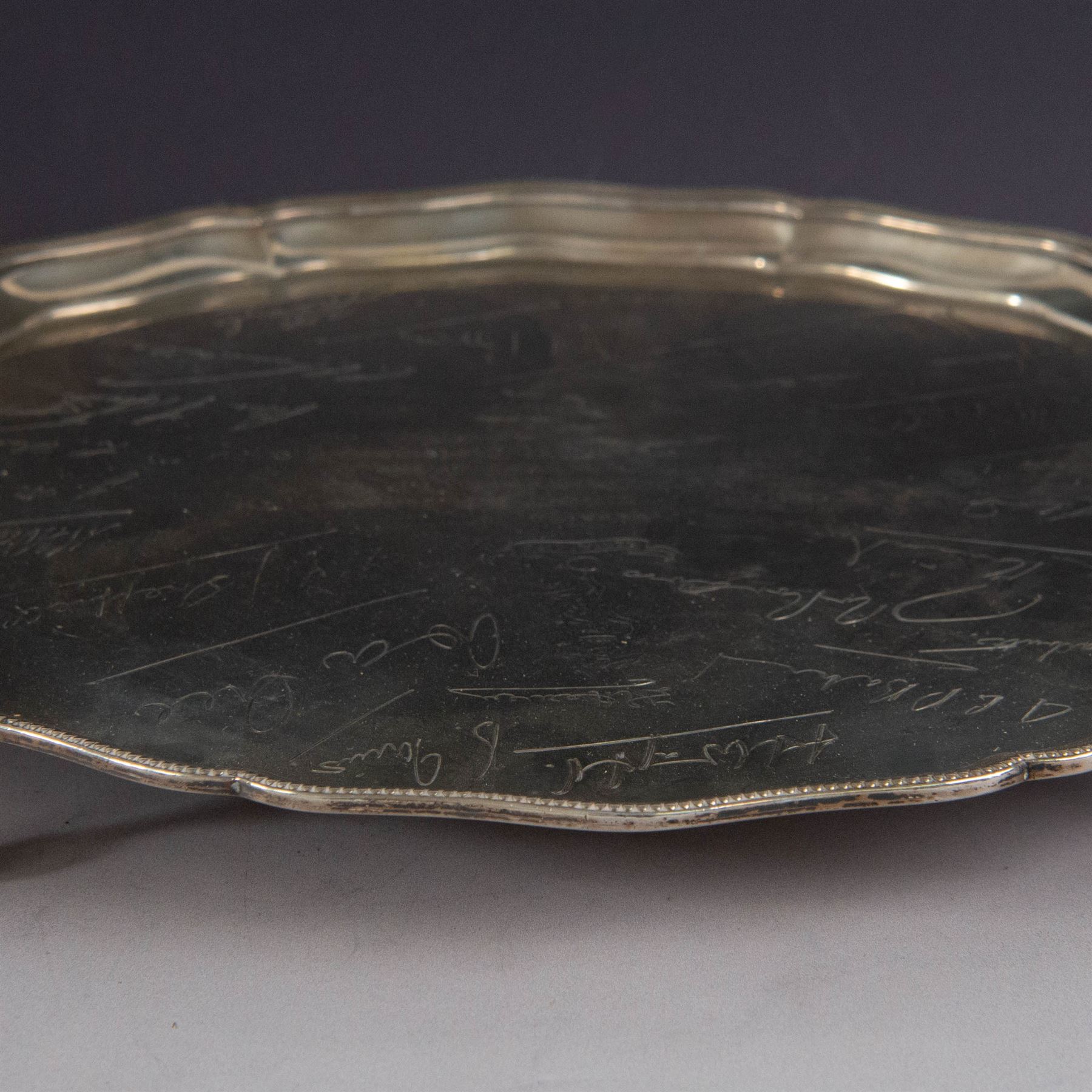 1930s silver salver, of circular form with beaded pie crust rim and upon four claw and ball feet, with presentation engraving to centre reading 'Presented to Second Lieutenant FR Himsworth Royal Signals by the Officers of the 50th Nottingham Motor Divisional Signals on the Occasion of his Marriage 10th September 1939', bordered by the engraved signatures of his colleagues, hallmarked Barker Brothers Silver Ltd, Birmingham 1938, D25cm