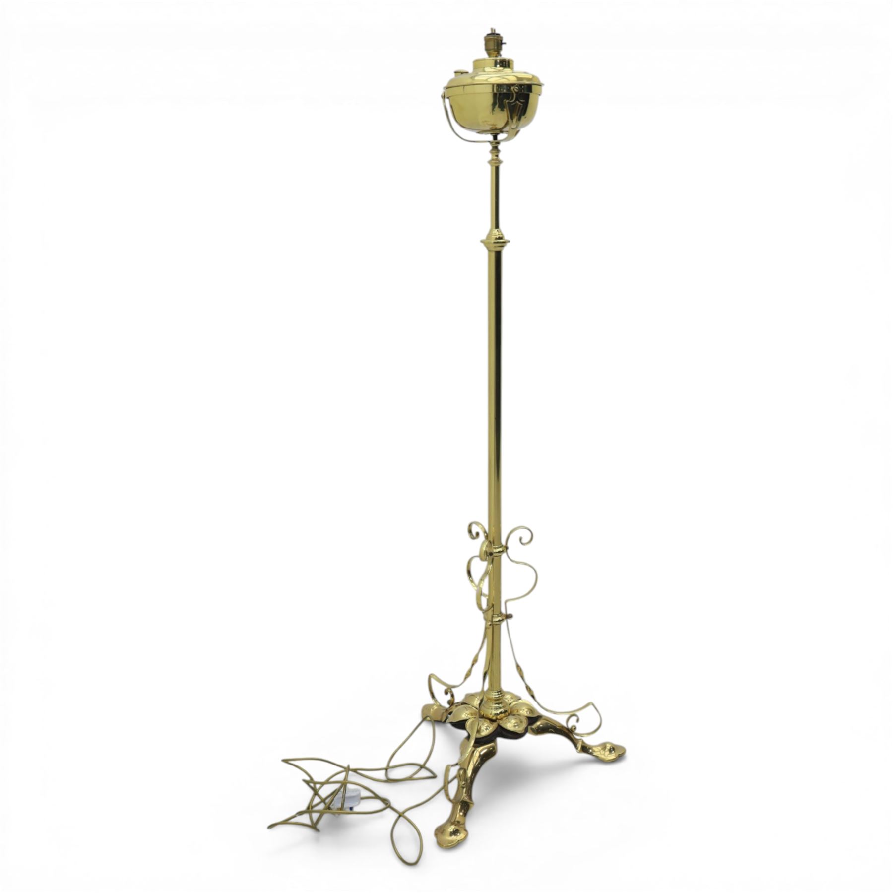 20th century brass standard lamp, urn form reservoir top with hinged cover, on a slender column with knopped detail, the stem fitted with scrolling supports, raised on a triform base with shaped cabriole supports terminating in pad feet