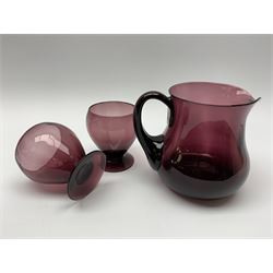 19th century amethyst glass jug, H14cm, together with a pair of later amethyst glass goblets, H10cm 