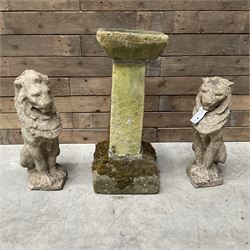 Pair of cast stone seated garden lions, a stone bird bath and various pots and planters