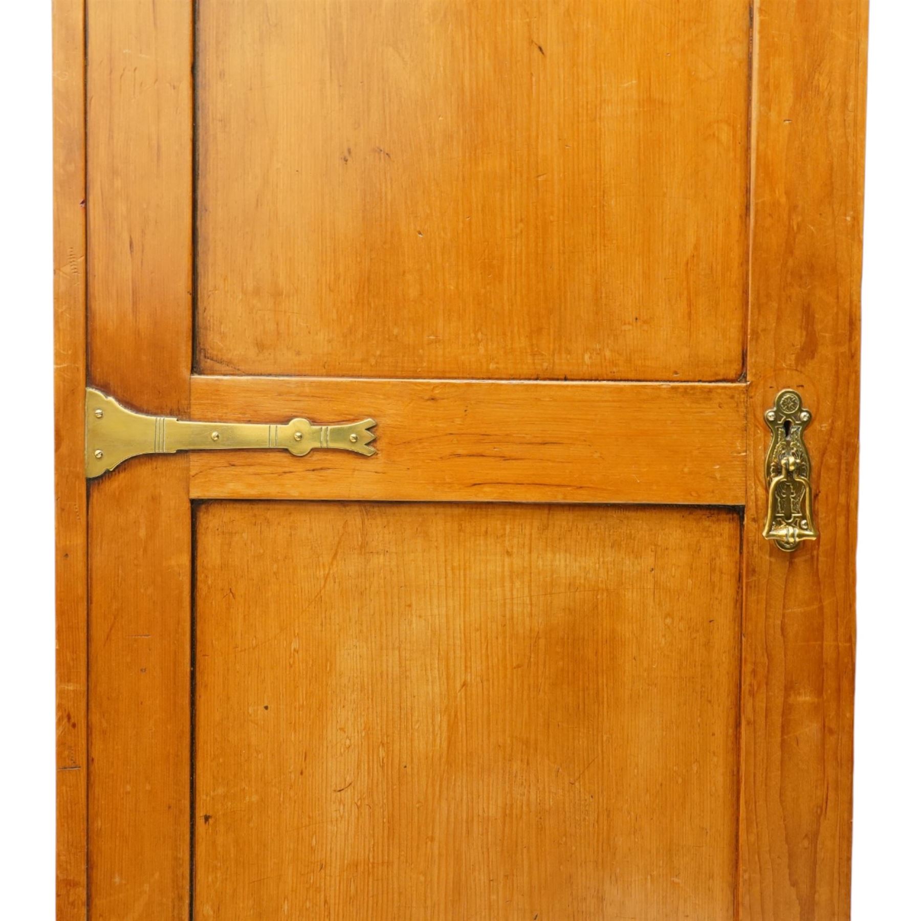 Late 19th century Arts & Crafts stained pine single hall wardrobe, single panelled door with brass fittings enclosing sliding tray to top with hanging rail and hooks, hinged box seat to base, on compressed bun feet