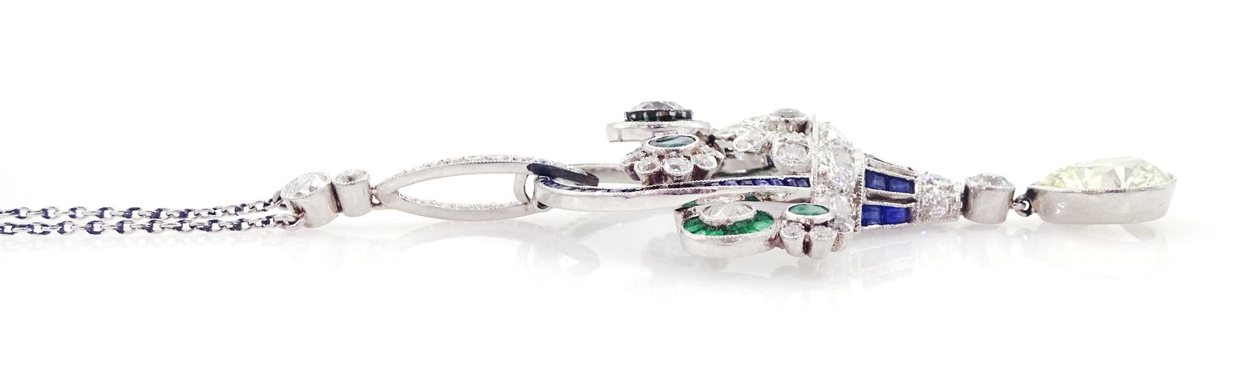 Art Deco platinum milgrain set diamond, emerald and sapphire flower basket pendant necklace, the basket set with old cut diamonds, calibre cut sapphires and emeralds, diamonds approx 2.00 carat, suspending a single pear cut diamond of approx 2.05 carat, on a platinum trace link chain necklace, stamped Plat, circa 1915-1920, in fitted box by Licht & Morrison, London